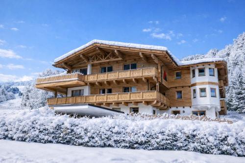 a log house in the snow at Apartments Niederseer in Saalbach-Hinterglemm
