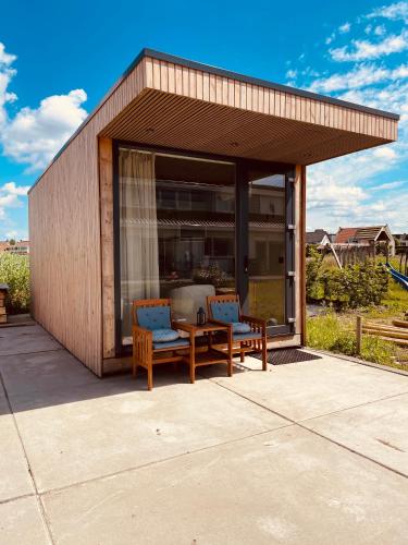 a pavilion with two benches and a table and chairs at B&B Pardoen in Poortugaal