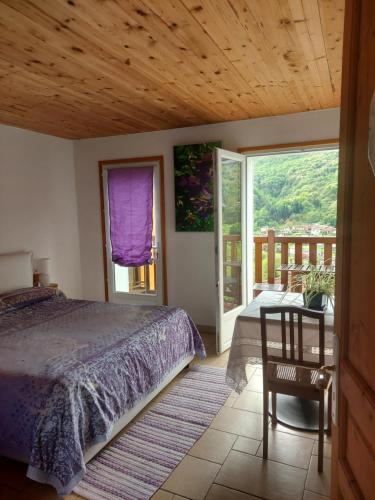 a bedroom with a bed and a wooden ceiling at La Nave Monteggio in Monteggio
