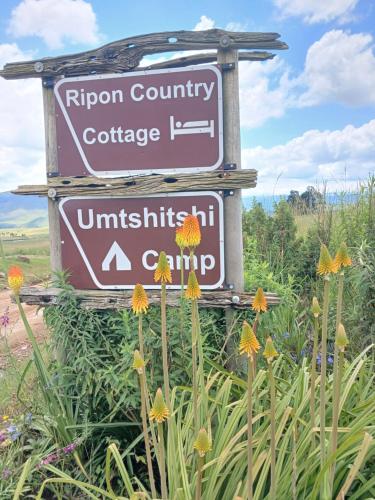 a sign for the rijon country courthouse courthouse anduniversity of camino at Umtshitshi Camp Site in Himeville