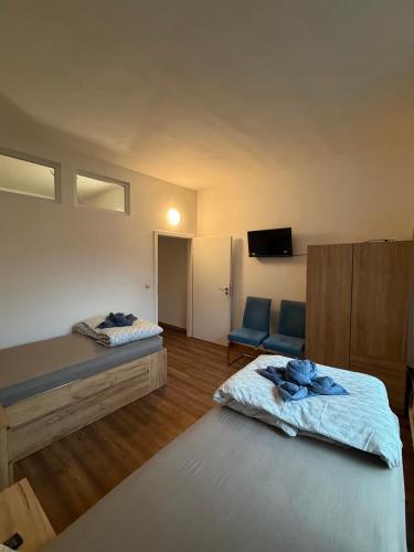 a room with two beds and a chair in it at Frisch sanierte Ferienwohnung in Grabow in Grabow