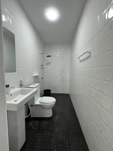a bathroom with a toilet and a sink at Andrella Rest House in Mannar