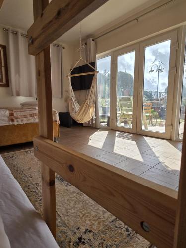 a bedroom with a hammock in a room with windows at פסטרנק אירוח יער אודם in Odem