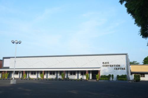 a large building with a sign on the side of it at Ravi Convention Centre in Rājānagaram