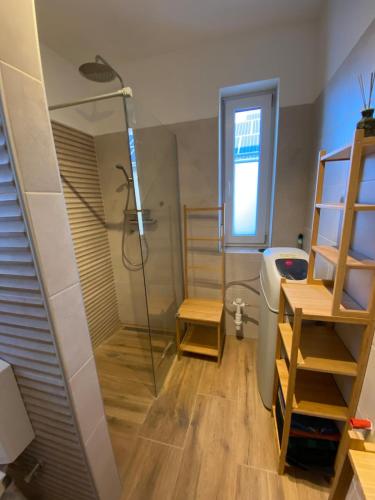 a bathroom with a shower and a toilet and a sink at Aura Vendégház in Révfülöp