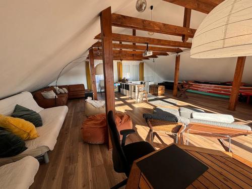 a living room with couches and tables in a tent at Aura Vendégház in Révfülöp