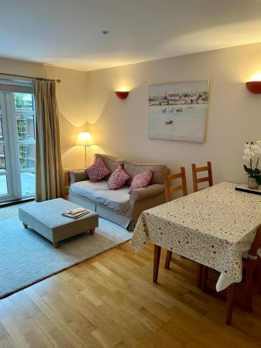 a living room with a couch and a table at Yew Tree House in Arundel