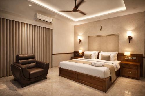 a bedroom with a bed and a chair at Amara Lux Rivage wynad in Vythiri