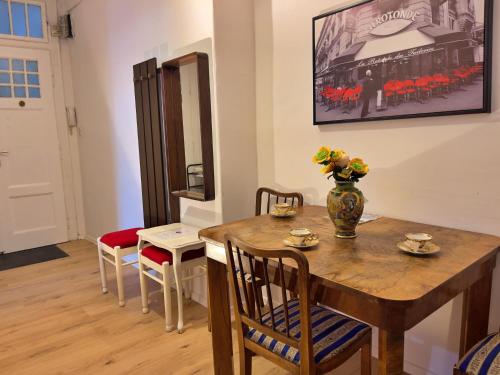 a dining room with a wooden table and chairs at Sarajevo Main Street Residence in Sarajevo