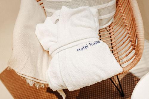 a pile of towels sitting on a wicker chair at Hotel Reindl Suiten & Appartments in Bad Füssing