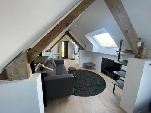 a living room with a couch and a window at Aplusstudio in Zottegem