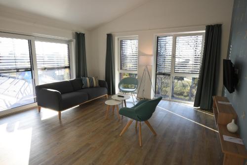 a living room with a couch and a chair at Steverbett Hotel in Lüdinghausen