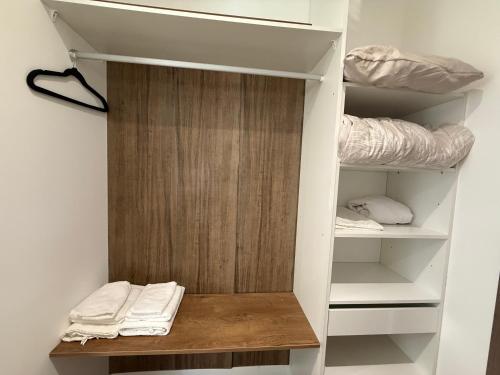 a closet with a wooden door and some towels at Le 6 by Montélimar in Montélimar