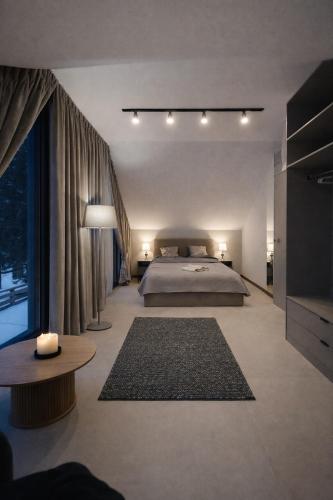 a large bedroom with a bed and a large window at Oaza Radęcin in Woldenberg Neumark