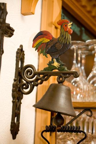 a wooden chicken on top of a bell at Zum Fally - Landgasthof in Kirchberg am Wechsel