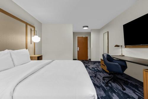 a hotel room with a bed and a desk and a chair at Fairfield Inn & Suites Billings in Billings