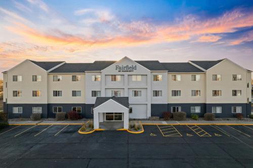 a large white hotel with a parking lot at Fairfield Inn & Suites Billings in Billings