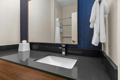 a bathroom with a sink and a mirror at Fairfield Inn & Suites Billings in Billings