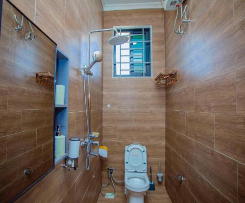 a bathroom with a toilet and a shower at Nadyapartment in Dodoma