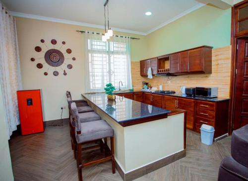 a kitchen with a large island in a room at Nadyapartment in Dodoma