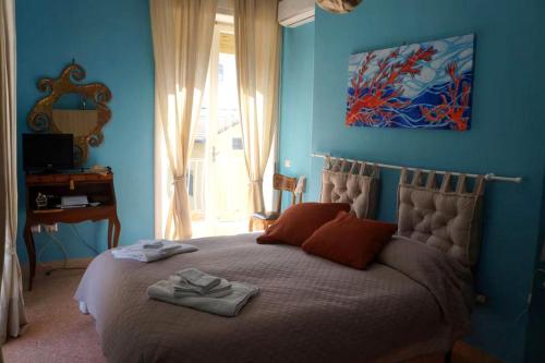 a bedroom with a large bed with blue walls at SergioCasa con vista a mare in Castellammare di Stabia