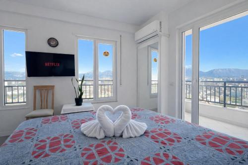 a bedroom with a bed with two white hearts on it at Romantic Penthouse with Mountains View in Kashari