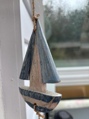 a bird feeder hanging from a window at Coombe Corner Cornwall in Bude