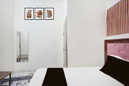 a white bedroom with a black and white bed at Hotel O Highway Kitchen in Bara Khera