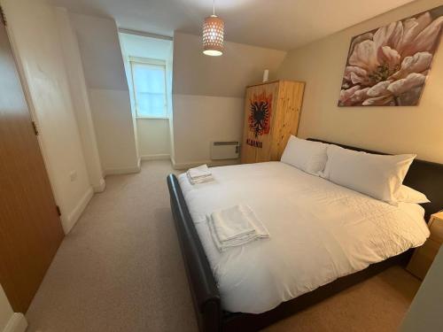 a bedroom with a large white bed in a room at Comfort Arena in Colchester