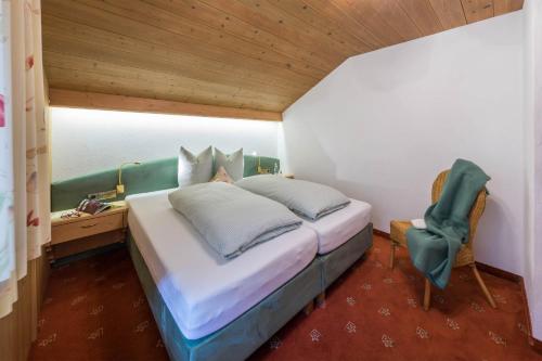 a bedroom with a bed and a desk and a chair at Aparthotel Gallahaus in Zell am Ziller