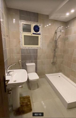 a bathroom with a sink and a toilet and a tub at horizon sky pyramids in Cairo