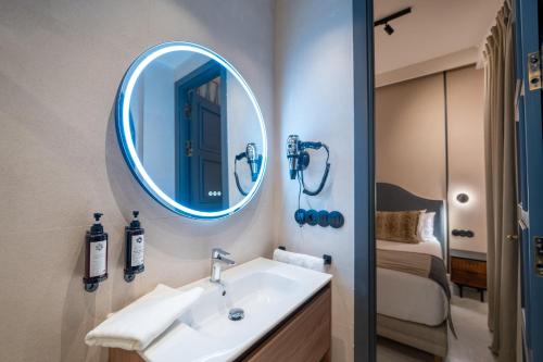 a bathroom with a sink and a mirror at De Domínguez Hotel Boutique in Seville