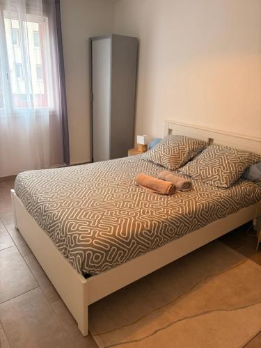 a bed with two shoes on it in a bedroom at Nice tourist apartment in Digoin