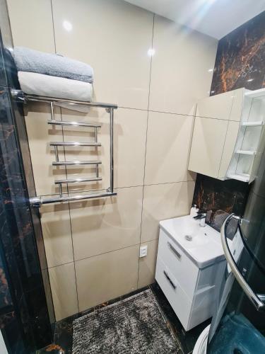 a bathroom with a sink and a toilet and a shower at G Apartments in Rēzekne