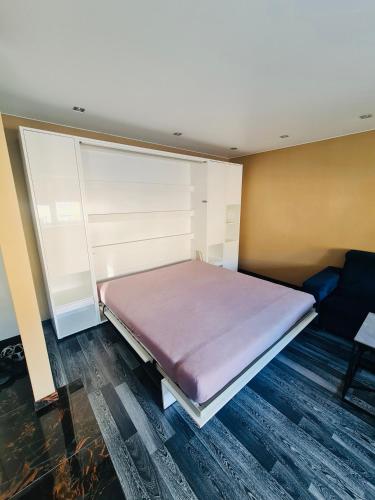 a small bedroom with a bed and a couch at G Apartments in Rēzekne
