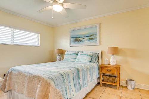 a bedroom with a bed and a ceiling fan at Cute Cocoa Beach Condo w/ Pool & Beach Access! in Cocoa Beach