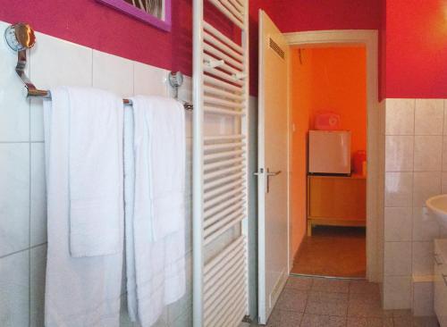 a bathroom with white towels hanging on a wall at Ferienwohnung Grimmer in Weil am Rhein