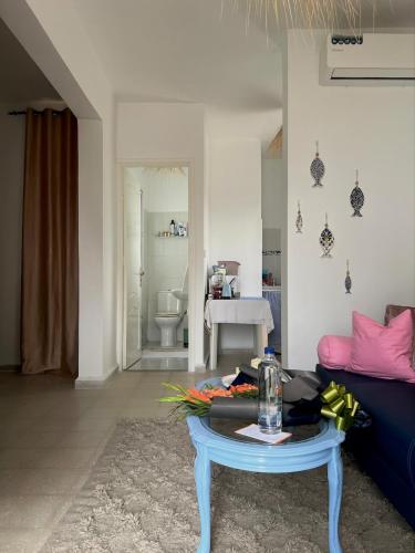 a living room with a couch and a table at Cozy Sousse Studio in Hammam Sousse