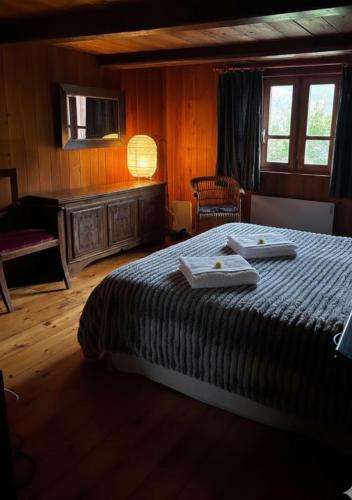 a bedroom with a bed with two towels on it at Relax alpino con sauna - Ca da Viola in Cavagnago
