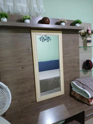 a mirror sitting on a counter with a table at Casa de Vivendas in Domingos Martins