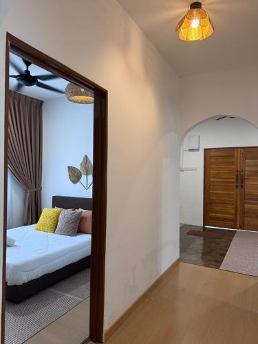 a living room with a couch and a mirror at Rooma Bali Jeram in Kuala Selangor