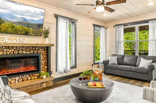 a living room with a couch and a fireplace at Ridgetop Hideaway in Pigeon Forge