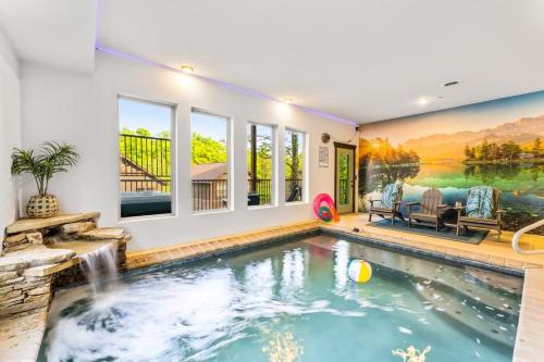 a swimming pool with a waterfall in a house at Ridgetop Hideaway in Pigeon Forge