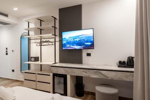 a living room with a tv on a wall at Hotel Resol 2 in Ksamil