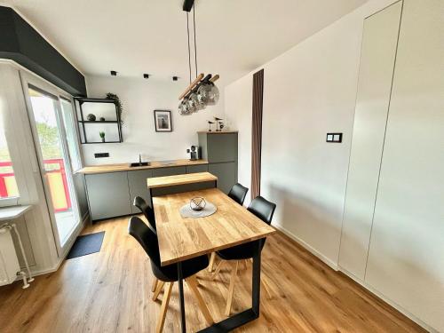 a dining room with a wooden table and chairs at Terrassenhaus, FeWo 45 in Duhnen