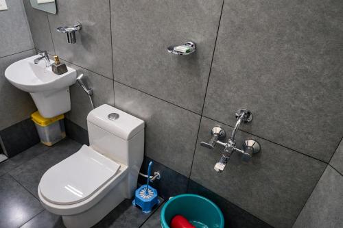 a small bathroom with a toilet and a sink at Crystal Homestay in Trivandrum