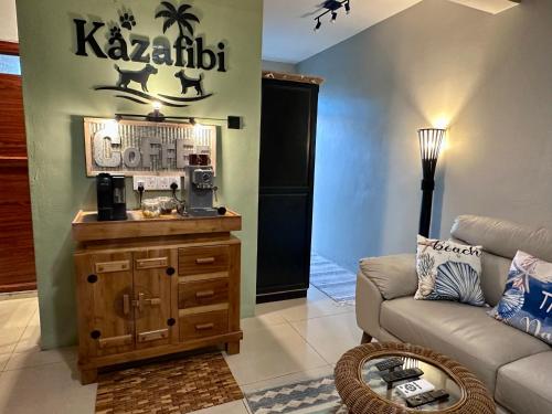 a living room with a couch and a coffee table at Flic en Flac Beachfront Apartment, KAZAFIBI in Flic-en-Flac