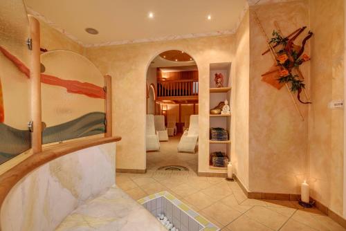 a large room with a staircase and a living room at Garni Apparthotel St Valentin in San Valentino alla Muta