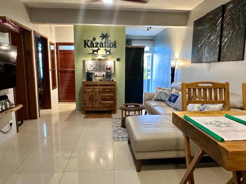 a living room with a couch and a table at Flic en Flac Beachfront Apartment, KAZAFIBI in Flic-en-Flac
