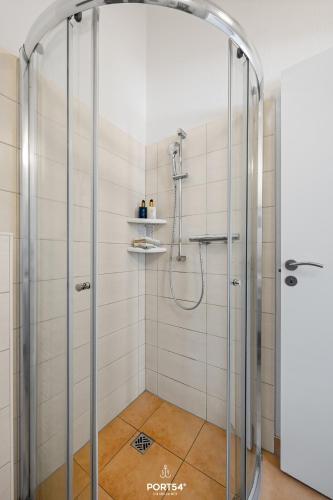 a shower with a glass door in a bathroom at Ferienhaus Bergoase - Sankt Andreasberg im Harz in Sankt Andreasberg